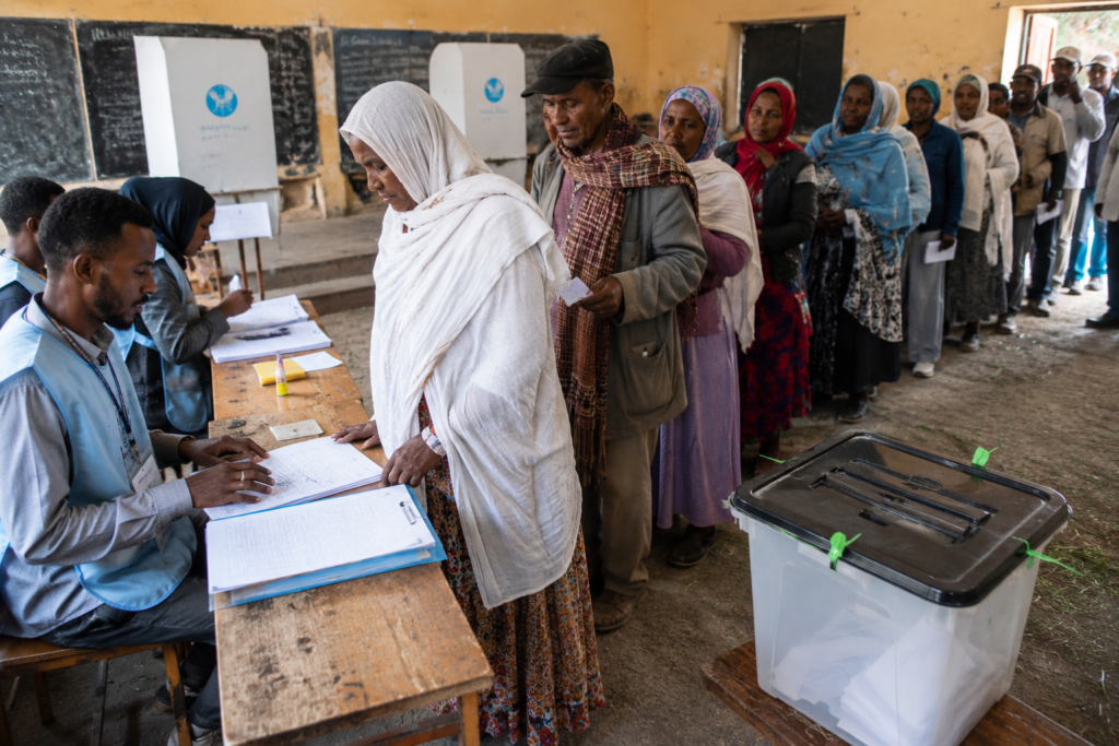Voters participating in an election in Ethiopia amid discussions about democracy, governance, and conflict challenges.